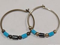 Both hoop earrings laid flat showing beads and hoop size