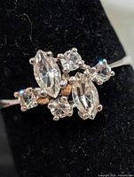 Close-up of ring cluster showing marquise and round stones