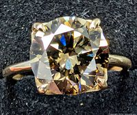 Top view showing cushion-cut lab diamond solitaire in four-prong 10K gold setting