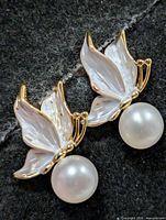 front view of earrings showing butterfly wing design and pearls
