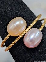 Close-up of both pearls and twisted band