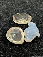 Three loose gemstones displayed on black background