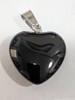 Front view of polished black onyx heart pendant showing bail attachment
