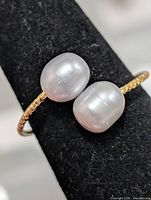 Top view of ring showing two pearls on gold-tone band