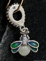 Front view of silver bee pendant with enamel wings and bead body