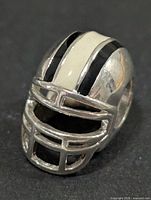 Front view of silver football helmet pendant showing facemask and enamel stripe