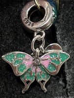 Front view of sterling silver butterfly pendant showing enamel colors and 925 stamp on bail