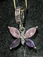 Front view of silver butterfly pendant showing stone colors and arrangement