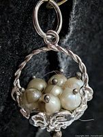 Front view of silver basket pendant with pearls