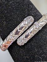 Close-up of ring top showing cubic zirconia settings and pattern detail