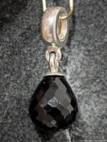 full view of silver bail and black onyx drop pendant