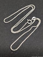 Full view of silver box chain laid flat