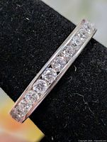 Side angle showing channel-set CZ stones along top of silver band