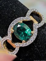 Top view of ring showing created emerald and CZ accents