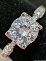 close-up of ring front showing round CZ and prongs
