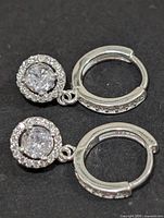 Front view of earrings showing CZ center stones and halo