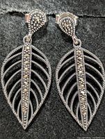 Front view of both silver marcasite leaf drop earrings