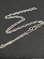 Full view of the 18" silver chain laid out showing overall length and link style