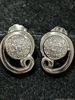 front view showing pavé CZ centers and scroll design