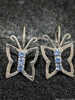 front view showing butterfly shape and blue stones
