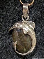 Front view of dolphin pendant showing labradorite cabochon