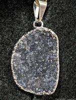 Front view of pendant showing druzy crystal surface and silver bezel