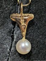 Front view showing textured silver mount and pearl