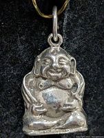 Front view of silver laughing Buddha pendant
