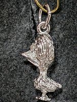 Front view of silver bird pendant showing overall shape and detail