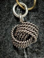 Front view of silver rope knot pendant with jump ring