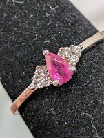 Front view showing pear ruby and accent stones