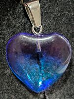 Front view of translucent purple heart pendant showing color gradation and bail