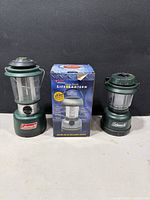 Two Coleman lanterns and one boxed Life Lantern shown together