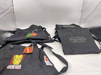Three aprons displayed; Iron Man apron lower left, two stacked Star Wars aprons right