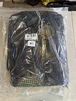 Front of sealed package showing koi and mandala design on black gi