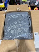 Grey boat cover folded in carton