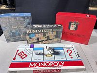 All four boxed games arranged together: Monopoly, Trivial Pursuit Volume II, Rummikub, Scattergories