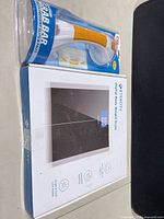 Boxed ETEKCITY digital scale and packaged suction grab bar side by side