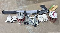 Overall lot layout with bag, sticks, helmets, pads, gloves