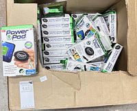 Open carton filled with boxed Power Pod chargers