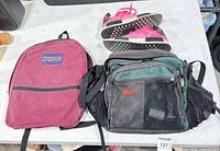 Overview showing Jansport backpack, REI bag, Adidas NMD sneakers