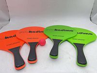 four Pro Kadima paddles and pink ball
