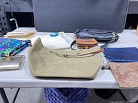 Group view of all handbags and clutches on table