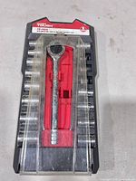 Front view of socket set in plastic tray showing ratchet and sockets