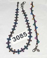 Necklace and bracelet laid flat showing full lengths and multicolour crystals