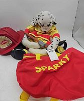 Overall lot showing Sparky plush, red bag, Tonka helmet