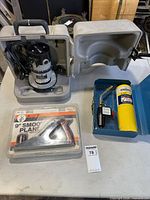 Overall lot showing router in case, plane package, torch kit