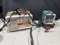Both Schauer battery chargers with cables visible