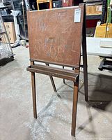 Front view of wooden easel showing board and tray