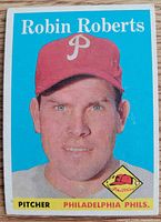 Front view of 1958 Topps Robin Roberts card showing portrait, player name and team pennant